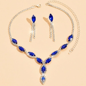 Macro view of blue marquise gemstone necklace and drop earrings set on silver base
