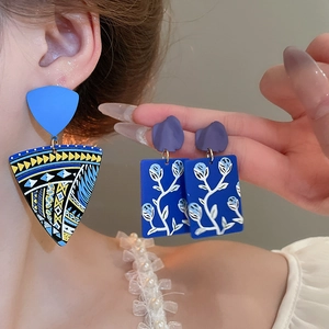 Detailed view of bohemian blue geometric acrylic earrings featuring floral patterns