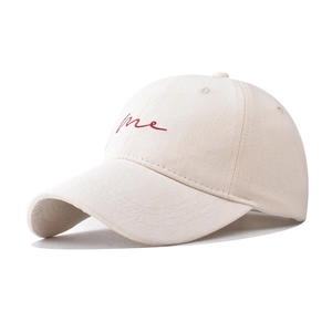 Detail of red me script embroidery on beige cotton canvas baseball cap crown