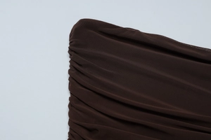 Detailed view of dark brown mesh fabric featuring elegant ruched and pleated textures