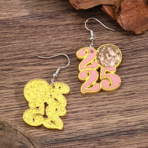 Detail of 2025 pink glitter acrylic star earrings with disco ball pendant for New Year party