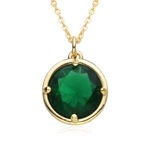 Macro shot of circular green zircon gemstone pendant on a polished gold chain