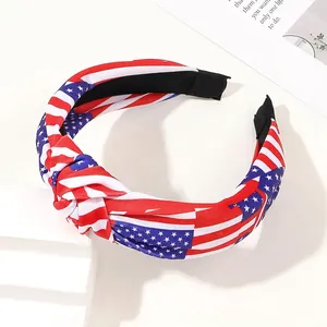Détail d'un serre-tête noué drapeau USA avec motifs étoiles et rayures sur socle blanc
