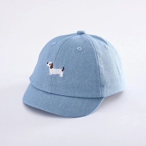 Close-up of light blue denim baby baseball cap with cute cartoon puppy embroidery