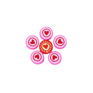 Flat lay of heart pattern polymer clay spacer beads for DIY jewelry making