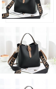 Detail of black bucket bag with brown strap buckle and wide patterned shoulder strap