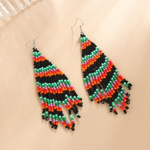 Detailed macro view of colorful handmade beaded tassel earrings with bohemian woven patterns