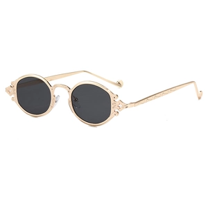 Retro punk oval tea-colored sunglasses with gold engraved metal frames and dark lenses