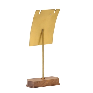 Close-up of walnut wood base and gold metal jewelry display stand for earrings