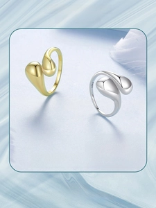 Detailed macro view of S925 sterling silver water drop rings in gold and silver finishes