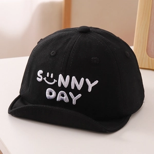 Detail of sunny day letter embroidery on a black soft brim baby baseball cap