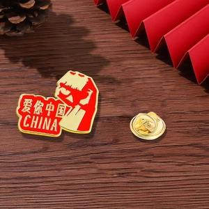 Macro shot of red heart and map enamel pin with China text and butterfly clutch