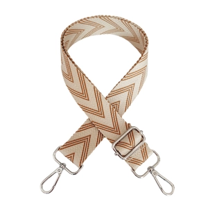 Detail of adjustable woven canvas strap with beige and brown chevron pattern and silver clips