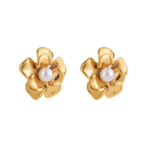 Detail view of 18k gold plated flower stud earrings with a white pearl center