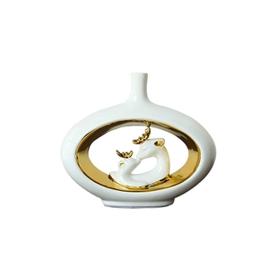 Modern white ceramic vase with golden interior and kissing deer sculptures for home decor