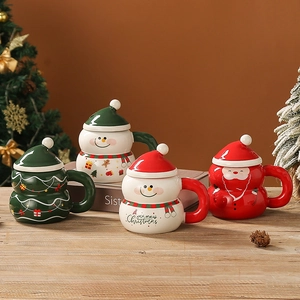Christmas ceramic mugs with snowman, Santa, and tree designs on a festive wooden table
