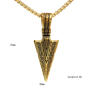 Detailed view of gold arrow pendant with textured surface and size specifications