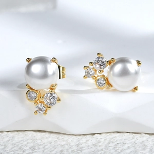 Elegant shell pearl and zircon stud earrings in gold finish for a minimalist chic style