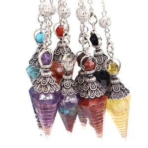 Collection of colorful natural crystal dowsing pendulums with vintage silver metal caps