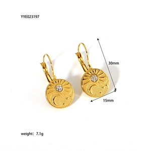 Detailed view of 18K gold plated sun and moon relief earrings with zircon stone inlay