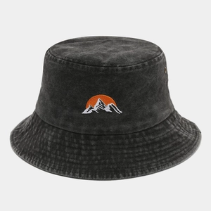 Detail of mountain sunrise embroidery on charcoal washed cotton bucket hat with metal eyelets