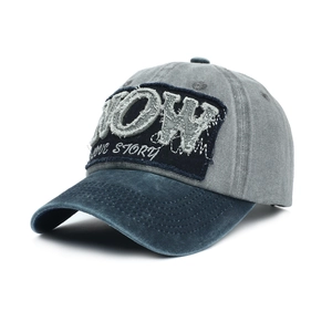 Detail of vintage washed baseball cap with NOW LOVE STORY patch embroidery and distressed edge