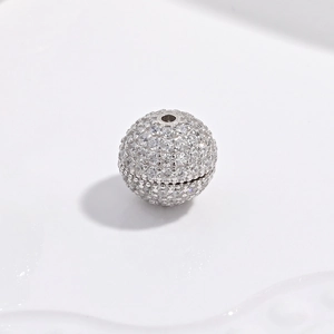 Macro detail of S925 sterling silver ball bead with pavé white zircon stone setting