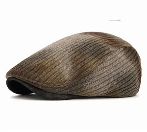 Detail of gray striped knit newsboy cap showing textured weave and black brim trim