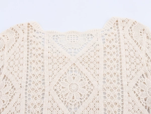 Detailed macro view of the intricate floral crochet and hollow-out lace texture on the top