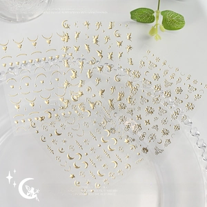 Detail of 3D embossed gold moon and fairy nail stickers with metallic stars and hearts