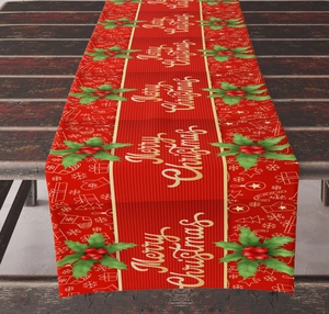 Detail of red Christmas table runner with gold Merry Christmas text and holly patterns