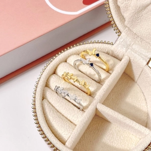 Close-up of four butterfly rings with blue crystals displayed in a jewelry box