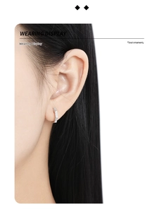 Close-up wearing display of S925 sterling silver hoop earrings with irregular textures