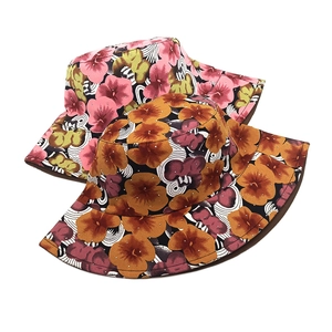 Digital floral print bucket hats with abstract patterns in pink and orange canvas fabric