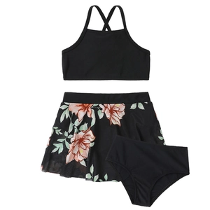 Detailed flat lay of three-piece girls swimsuit with tropical floral mesh skirt