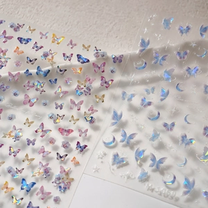 Detail of transparent glass butterfly nail stickers with floral and star motifs