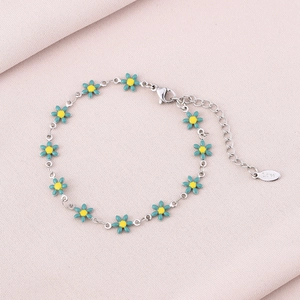 Detail of silver stainless steel daisy bracelet with blue enamel petals and lobster clasp
