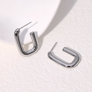 Macro detail of U-shaped stainless steel earrings with high polished silver finish