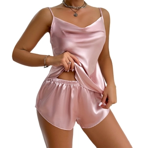Women's two-piece pink silk satin camisole and shorts pajama set with thin straps