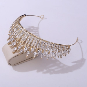 Detailed view of bridal crystal crown with gold finish and sparkling rhinestones