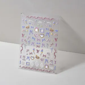 Macro view of 3D embossed nail art stickers with sweet ribbons, hearts and rabbit motifs