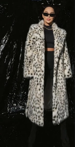 Detailed close-up of leopard print faux fox fur coat with black spots and soft texture