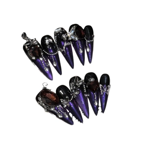 Handmade Gothic stiletto press-on nails in black and iridescent purple with 3D jewels