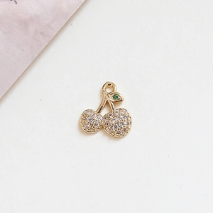 Close-up of golden cherry pendant with pavé set crystals for DIY jewelry making