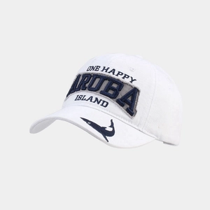 Macro detail of white cotton golf hat featuring Aruba Island embroidery and shark motif