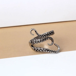 Macro detail of octopus tentacle ring featuring realistic suction cup texture and vintage finish