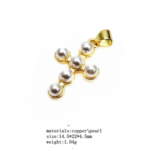 Detailed view of a gold-plated copper cross pendant with white pearls, 14.5x22mm size