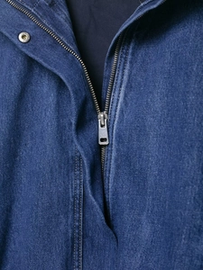 Macro detail of high-density blue denim fabric and metal zipper on vintage jacket