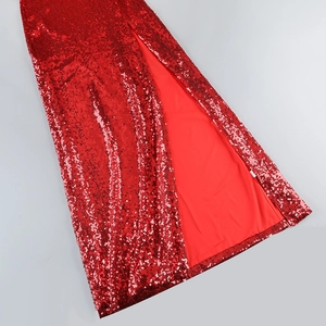 Detailed close-up of red sequined skirt featuring a high slit and smooth inner lining