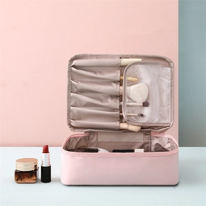 Détail de la trousse rose montrant les fentes pour pinceaux et le couvercle transparent